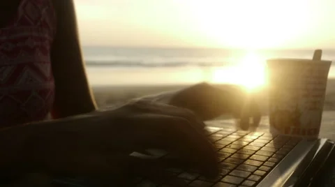 Hands typing on laptop at beach Stock Footage 60933667