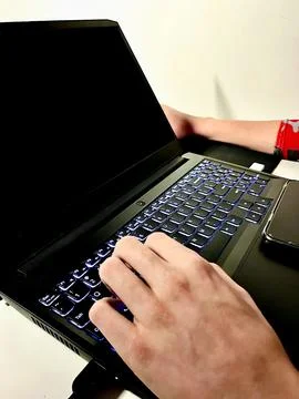 Hands typing on laptop with blank screen for online work remote learning co.. Stock Photos