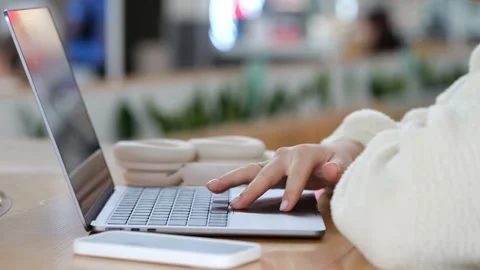 Hands typing on laptop in cafe with soft focus background Video stock 345943429