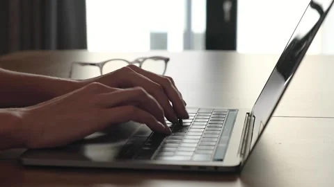 Hands typing on laptop computer keyboard close up Stock Footage 153928318
