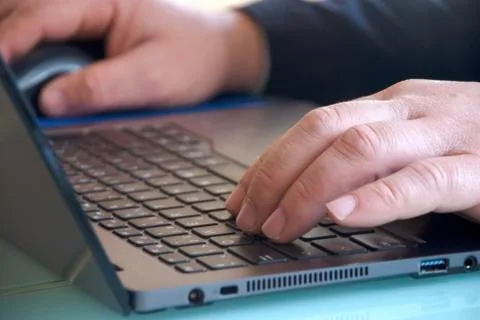 Hands typing on laptop computer keyboards Foto stock