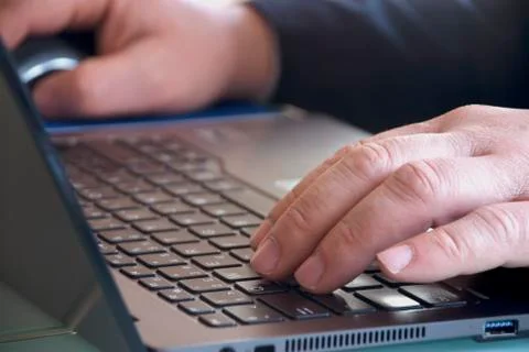 Hands typing on laptop computer keyboards Foto stock