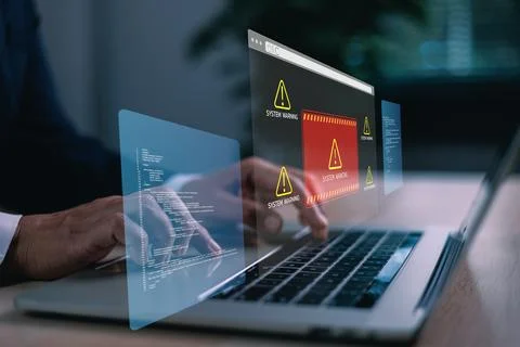 Hands typing on laptop with digital system warning alert on virtual screen,.. Stock Photos