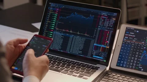 Hands Typing on Laptop Displaying Financial Charts in Modern Office Vídeos de archivo 336551038