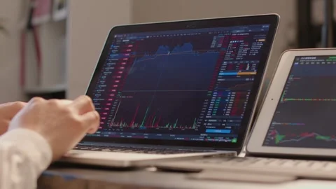 Hands Typing on Laptop Displaying Stock Market Charts Stockbeeldmateriaal 336550609