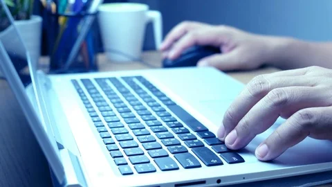 Hands typing on a laptop Stock Footage 77174468