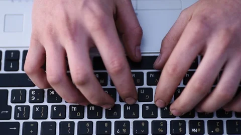Hands typing on a laptop Stock Footage 128970556