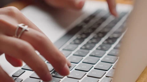 Hands typing on laptop in hotel desk focused freelance writer composing article Stock Footage 331748451