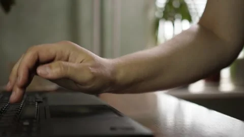 Hands typing on laptop keyboard and using touchpad close up low angle 스톡 동영상 344058189