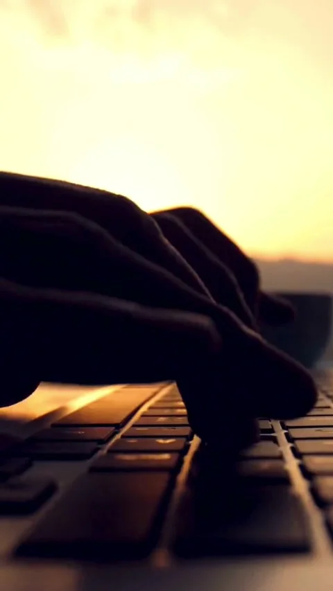 Hands typing on laptop keyboard during golden hour sunset Stock-Footage 331935768