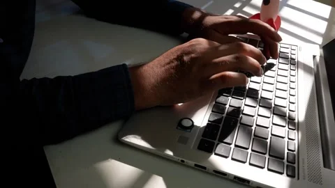 Hands Typing on Laptop Keyboard, Hands typing on a laptop keyboard in a dim.. Stock Footage 318578087