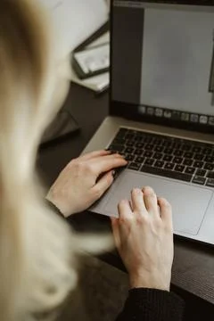 Hands Typing on Laptop Keyboard in Home Office Stock Photos