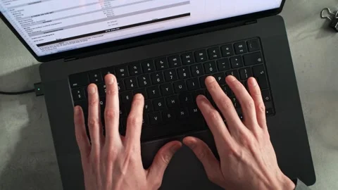 Hands Typing on a Laptop Keyboard Inputting Data into a Spreadsheet Stock Footage 286239729