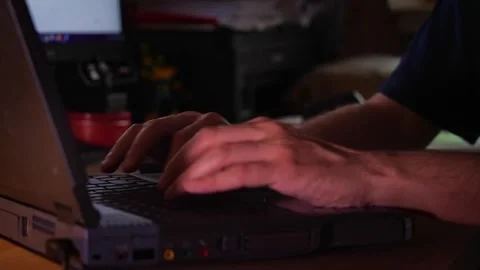 Hands Typing on a Laptop Keyboard in Low Light Stock Footage 310325025