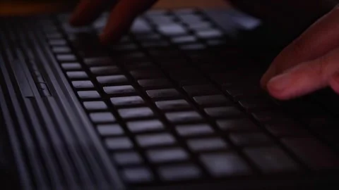 Hands Typing on a Laptop Keyboard in Low Light Stock Footage 310325080