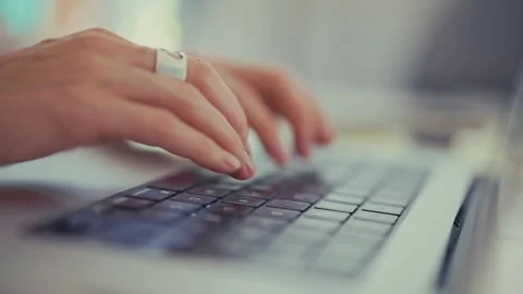 Hands Typing on a Laptop Keyboard in a Modern Workspace Stock Footage 304684545