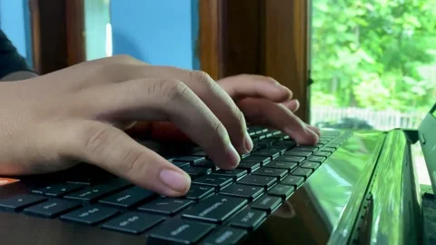 Hands Typing on Laptop Keyboard in Modern Workspace Stock Footage 325644062