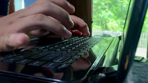 Hands Typing on Laptop Keyboard in Modern Workspace Stock Footage 325644064