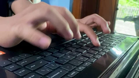 Hands Typing on Laptop Keyboard in Modern Workspace Stock Footage 325644096