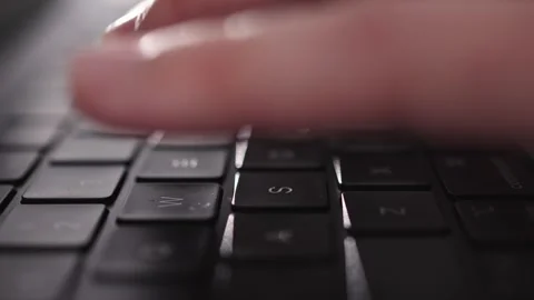 Hands typing on laptop keyboard in modern office interior. Stock Footage 331039443