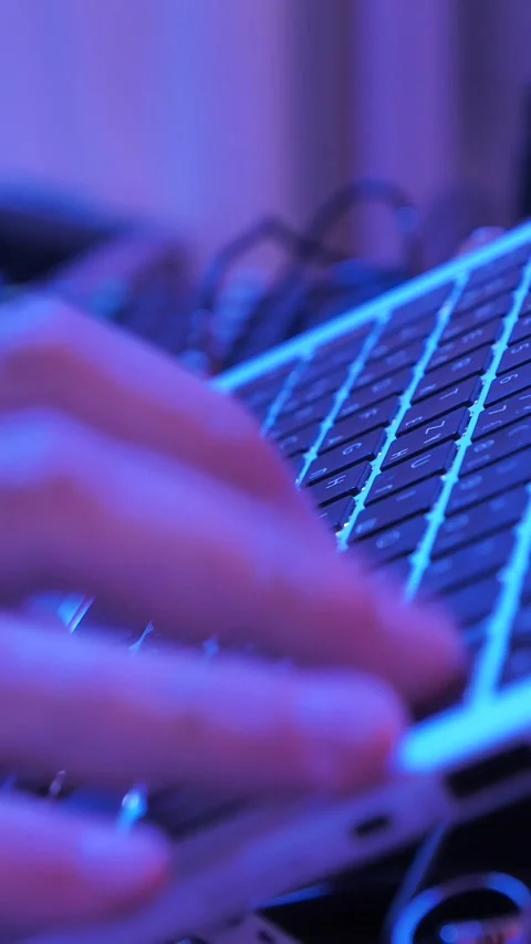 Hands typing on laptop keyboard in neon light Vídeo Stock 345115523