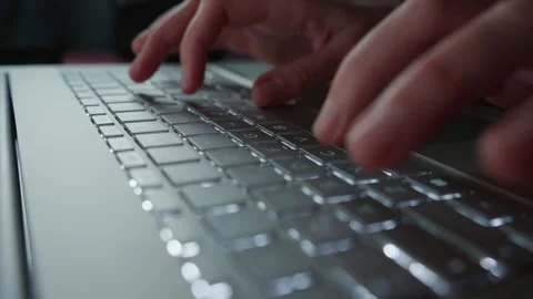 Hands typing on laptop keyboard at night Stock Footage 306580281
