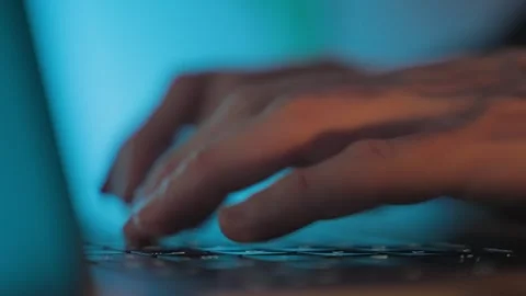Hands typing on laptop keyboard at night, hacking and cybercrime concept Stock Footage 327771608