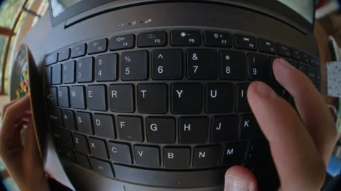 Hands Typing on Laptop Keyboard for Remote Work in Fisheye View Stock Footage 343712602