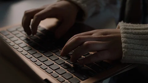 Hands typing on laptop keyboard in slow motion Video stock 128583973