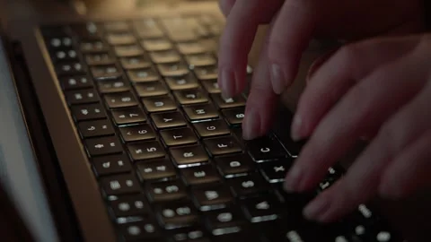 Hands Typing on Laptop Keyboard in Warm Light Close Up Video stock 344947445