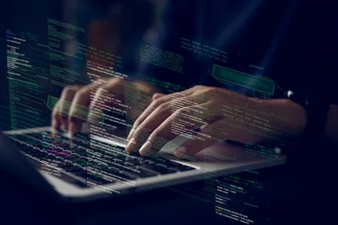 Hands typing on laptop with programming code on screen, representing softwa.. Foto stock