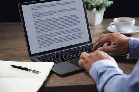 Hands typing on laptop with text document on screen at desk workspace, crea.. Foto stock