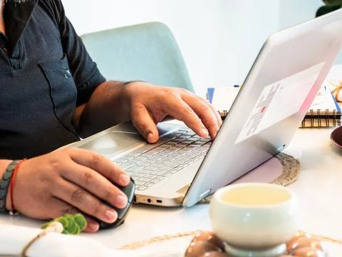Hands Typing on Laptop While Working Remotely 库存照片
