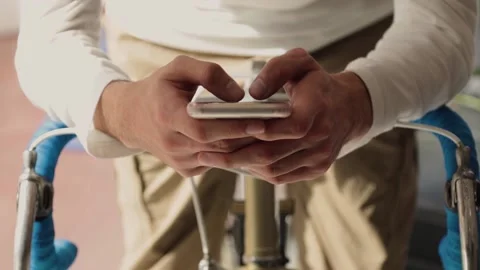Hands typing on a mobile phone while Stock Footage 205932298