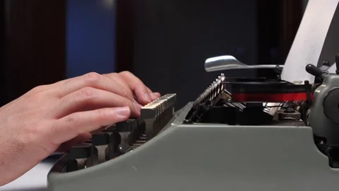 Hands typing on an old manual typewriter, close up of fingers striking keys as Stockbeeldmateriaal 321621765