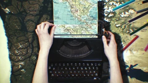 Hands typing on an old typewriter over a map-covered desk Stock Footage 346778178