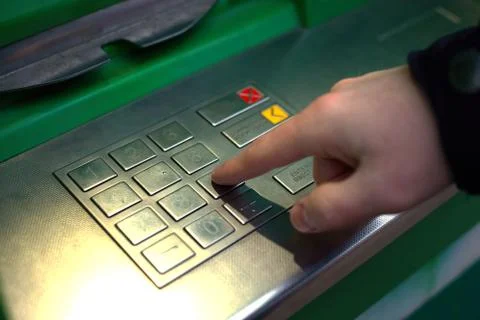 Hands typing PIN at ATM machine for cash money withdrawal Foto stock