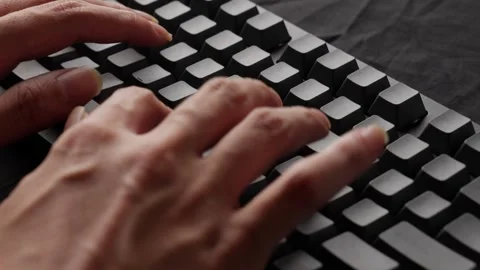 Hands typing rapidly on a mechanical keyboard, focus on fingers, tactile Stock Footage 268809427
