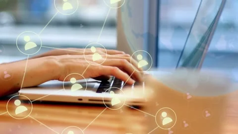 Hands typing starting focus shift, network overlay growing to visualize online Stock Footage 334351880