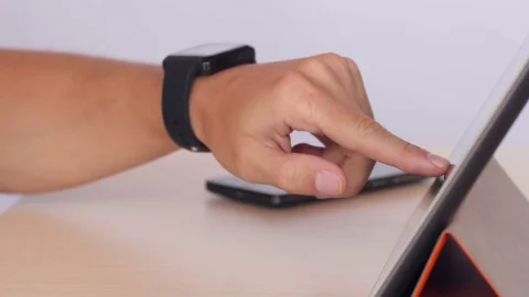 Hands typing on tablet and using smartwatch 库存影片 70198722