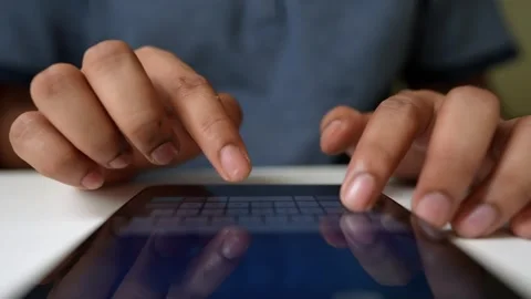 Hands Typing on Tablet Keyboard, Close-up of hands typing on a tablet keyboar Stock Footage 317736503