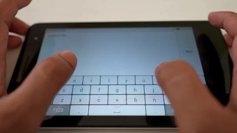 Hands typing on a tablet with a virtual keyboard Stock Footage 317736815