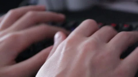 Hands typing text on a black glowing computer keyboard. Stock Footage 163970933