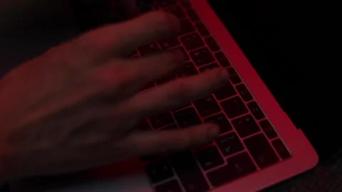 Hands typing text on laptop with neon red light frame side view Stock Footage 229706232