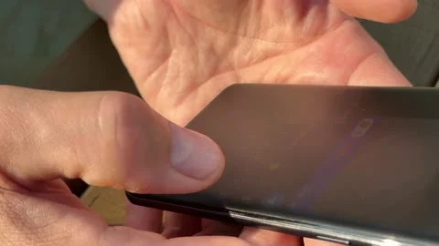 Hands typing text message outdoors. Male person actively using mobile app w.. Stock Footage 343258564