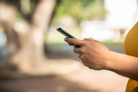 Hands typing text message on the phone Stock Photos