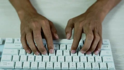 Hands typing on a white computer keyboard, Close-up overhead view of hands .. Stock Footage 347858773