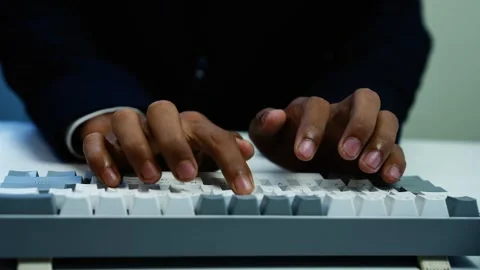 Hands Typing on White Computer Keyboard, Close-up of dark-skinned hands typ.. Stock Footage 348345104