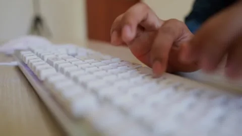Hands Typing on White Keyboard, Close-up of hands typing on a white keyboard Stock Footage 317736511