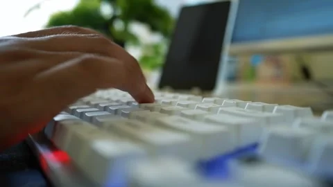 Hands Typing on White Keyboard, Close-up of hands typing on a white keyboar.. Stock Footage 317737157